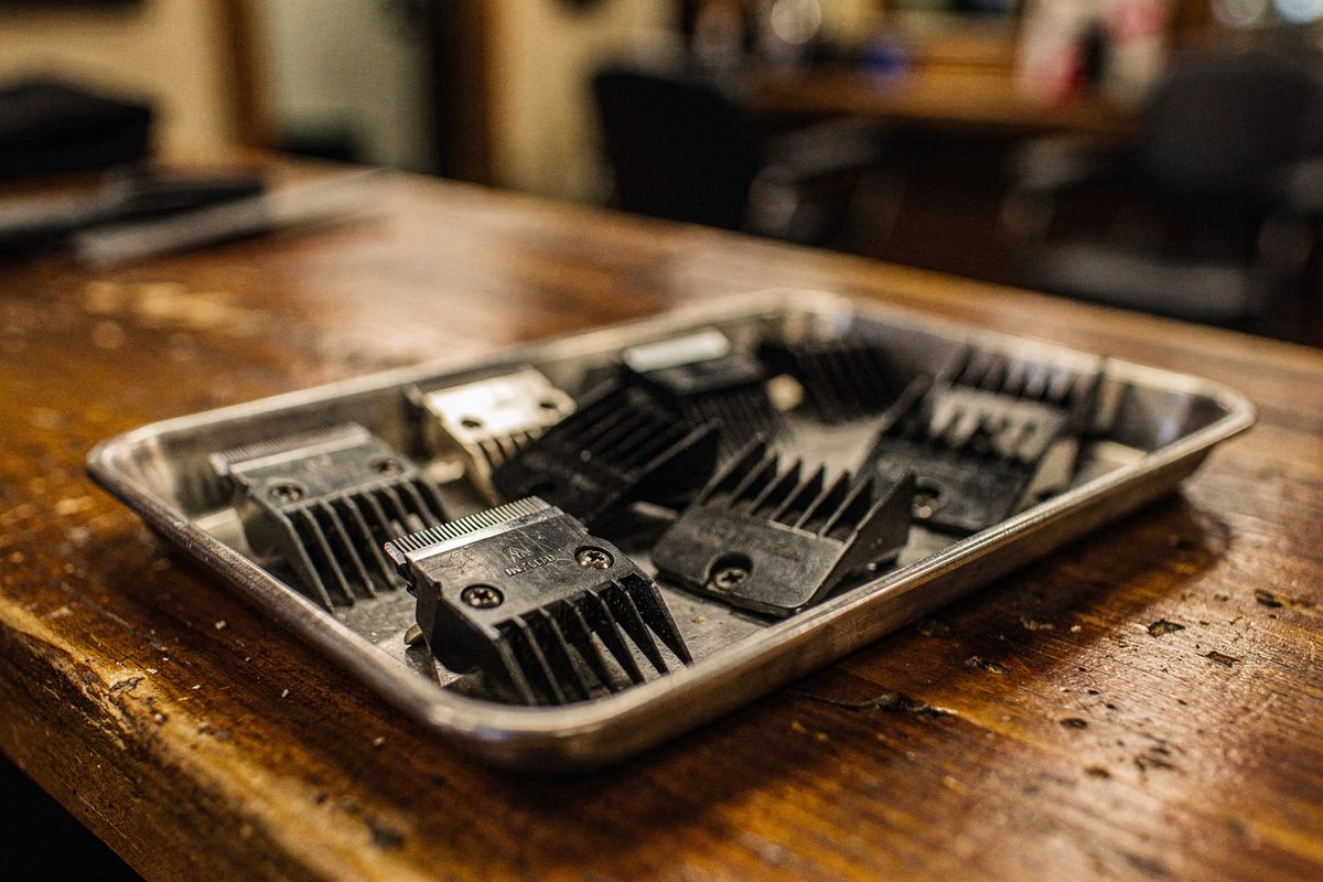Tray of clipper blades and combs laid out for sorting